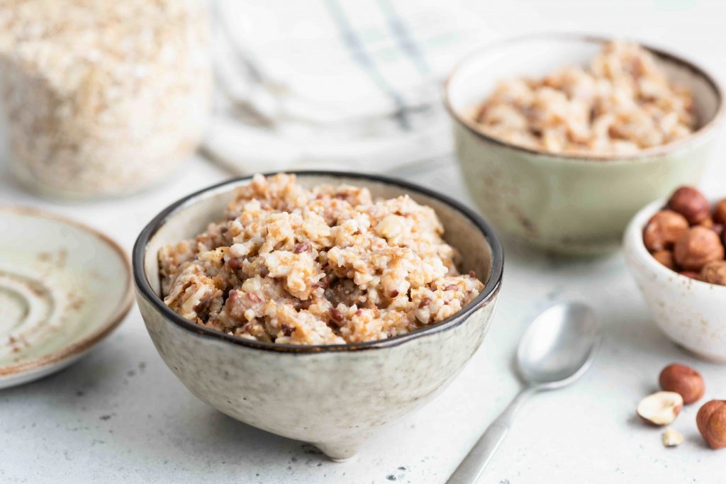 Oatmeal porridge with linseeds in bowl. Healthy vegan vegetarian breakfast rich in fiber and omega-3 amino acids